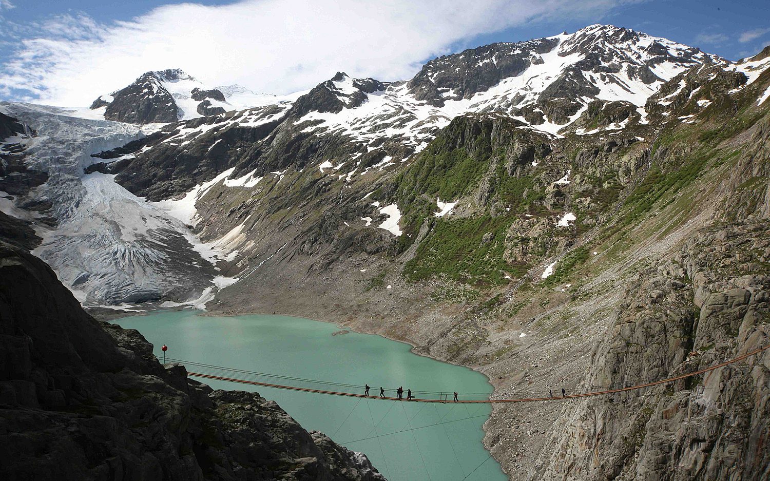 Melting Swiss glacier exposes bodies of two Belgian hikers missing since 1992; remains sent to Valais Hospital for identification