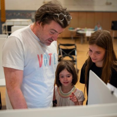 Dad with daughters voting TWE