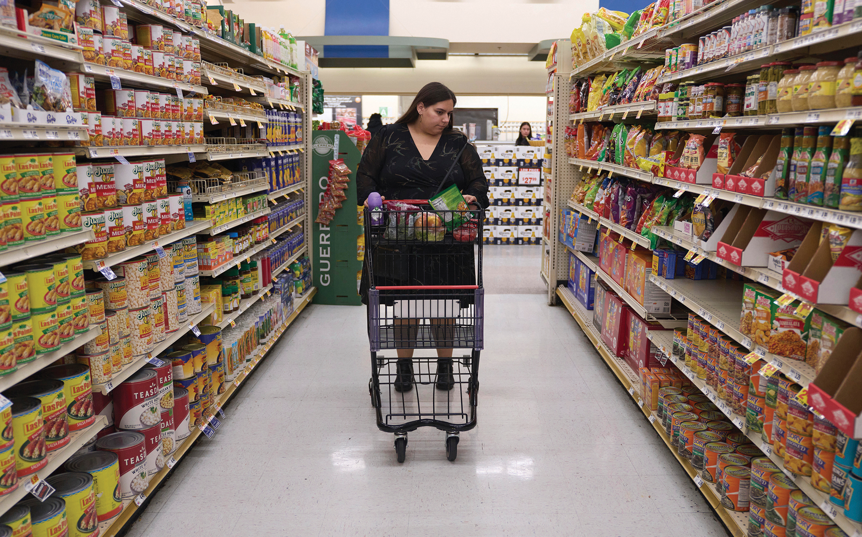 A woman who depends on SNAP benefits shops for groceries at a supermarket in Bellflower, Calif.