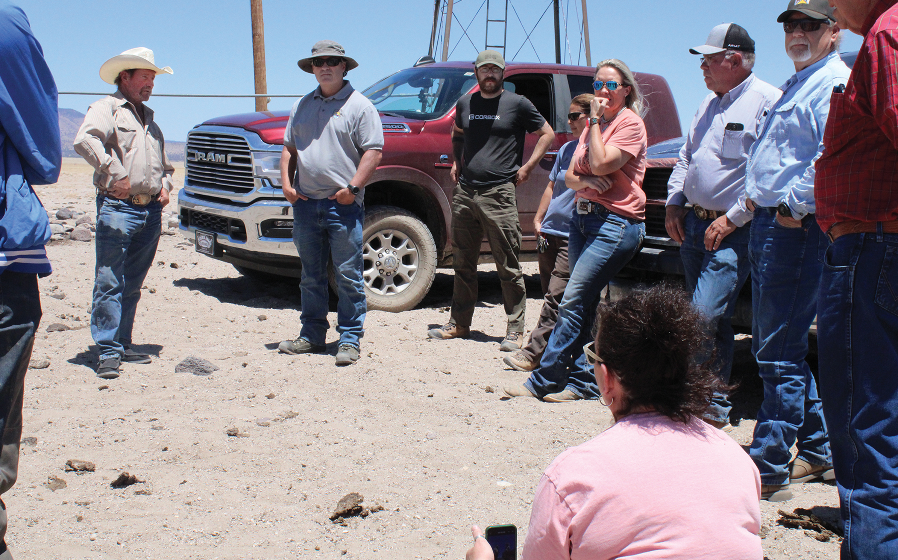 Audrey McQueen (fifth from left) and other ranchers meet with Brady McGee (second from left) at Harriet Ranch.